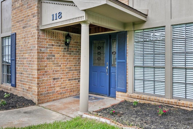 view of exterior entry with a porch