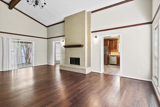 unfurnished living room featuring a notable chandelier, beam ceiling, wood-type flooring, and a fireplace