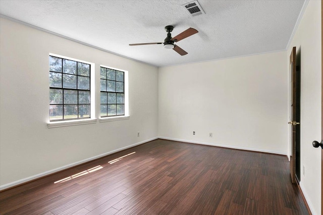 empty room featuring ceiling fan, dark wood-type flooring, and a textured ceiling