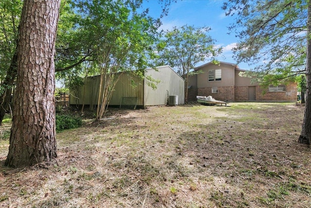 view of yard with an outdoor structure and central air condition unit