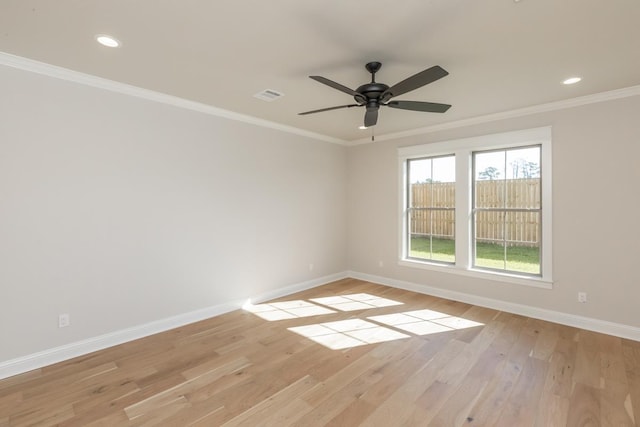 empty room featuring crown molding, ceiling fan, and light wood-type flooring