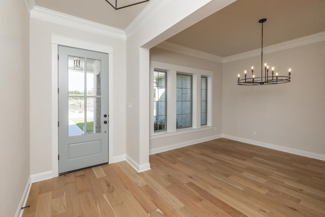 entryway with crown molding, a chandelier, and light hardwood / wood-style flooring