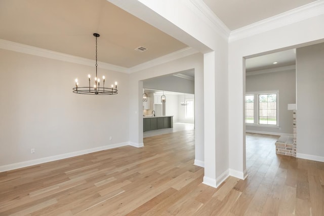 unfurnished dining area featuring crown molding, a chandelier, and light hardwood / wood-style flooring