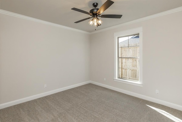 empty room with ceiling fan, ornamental molding, and carpet floors