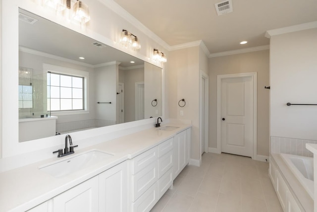 bathroom with a washtub, vanity, tile patterned flooring, and ornamental molding