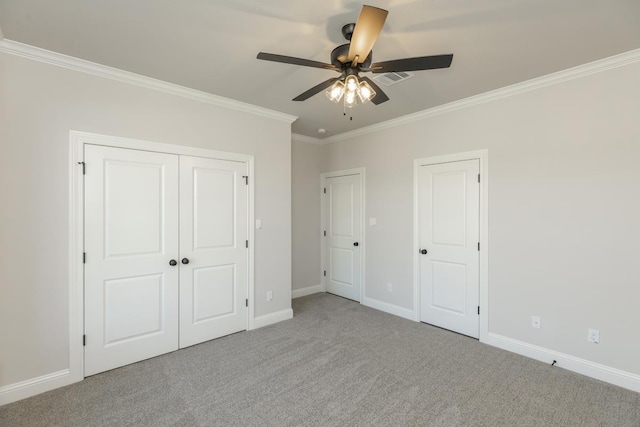 unfurnished bedroom featuring crown molding, ceiling fan, and light carpet