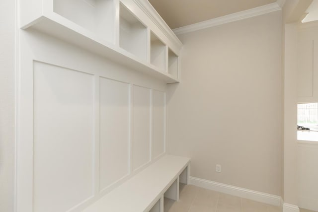 mudroom with light tile patterned floors and crown molding