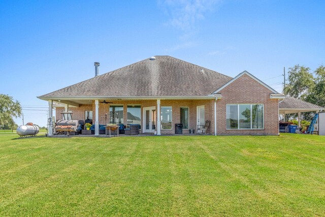 back of property featuring a lawn, an outdoor living space, ceiling fan, and a patio area