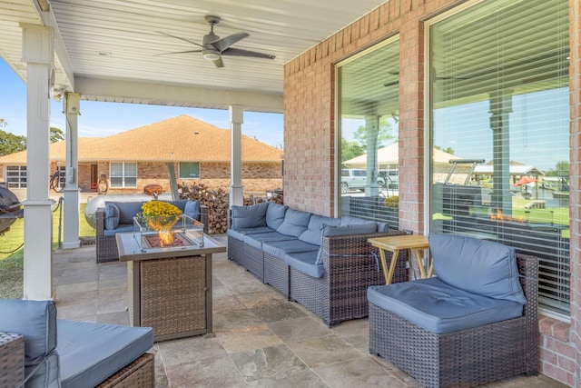 view of patio / terrace with an outdoor living space with a fire pit and ceiling fan