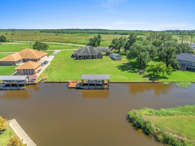 birds eye view of property with a rural view and a water view