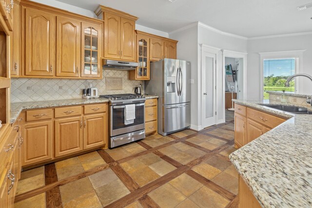 kitchen with sink, light stone counters, decorative backsplash, appliances with stainless steel finishes, and ornamental molding