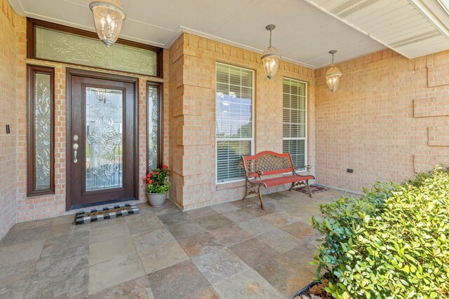 view of exterior entry with covered porch