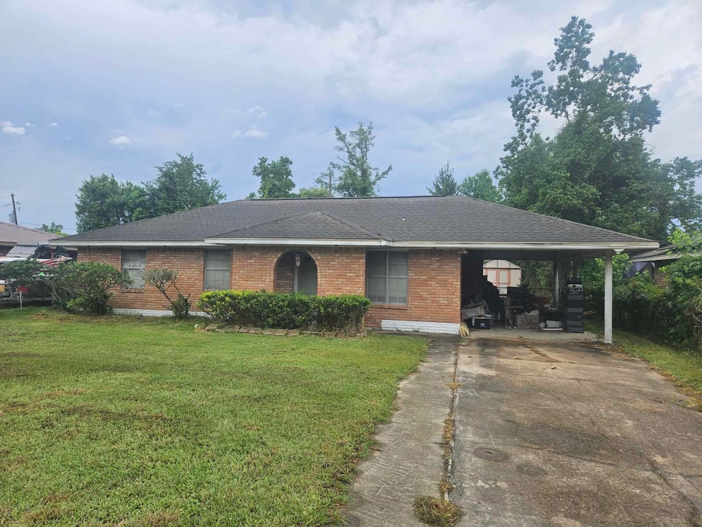 320 Beach, Vidor, TX 77662 - ranch-style house with brick siding, driveway, a front lawn, an attached carport, and a shingled roof
