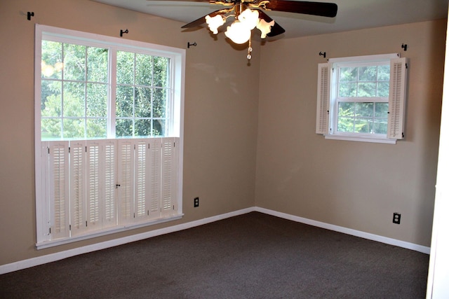 carpeted empty room with ceiling fan and plenty of natural light