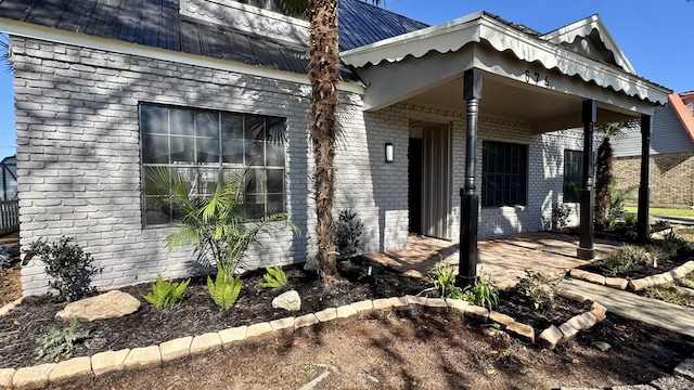 674 Ridgewood Dr, Port Neches, TX 77651 - view of side of property with brick siding and metal roof