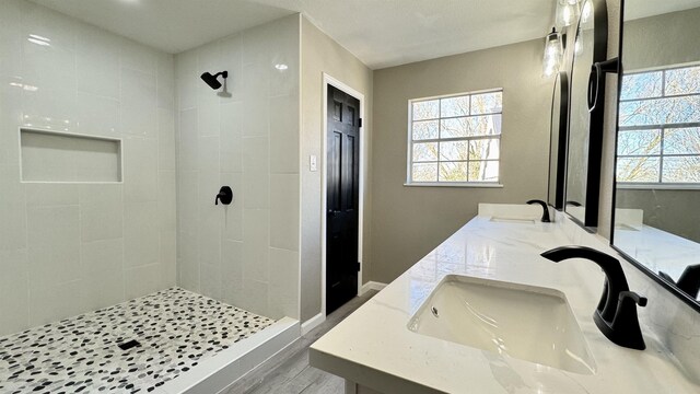 674 Ridgewood Dr, Port Neches, TX 77651 - bathroom with a tile shower, wood finished floors, and double vanity