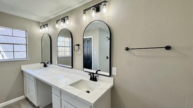 674 Ridgewood Dr, Port Neches, TX 77651 - bathroom featuring double vanity, wood finished floors, and a textured wall