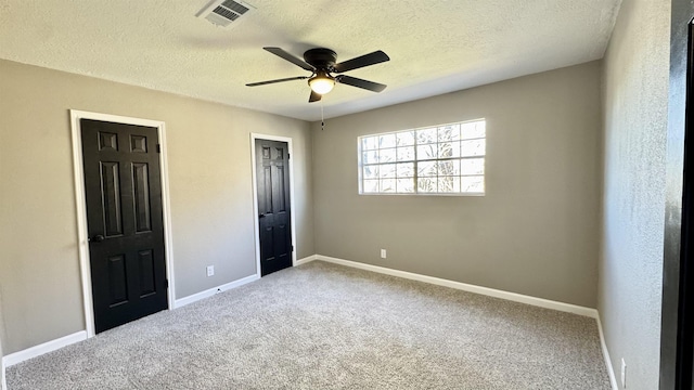 674 Ridgewood Dr, Port Neches, TX 77651 - unfurnished bedroom with carpet flooring, baseboards, a textured ceiling, and ceiling fan