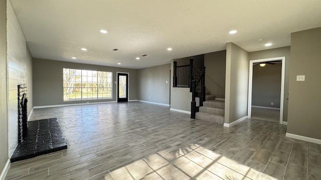 674 Ridgewood Dr, Port Neches, TX 77651 - unfurnished living room featuring wood tiled floors, recessed lighting, baseboards, stairway, and a ceiling fan