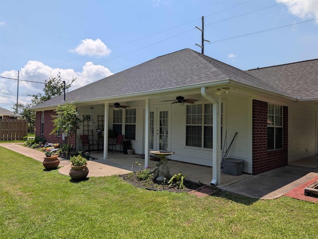 6220 32nd St, Groves, TX 77619 - back of house featuring a patio area, a ceiling fan, roof with shingles, and brick siding
