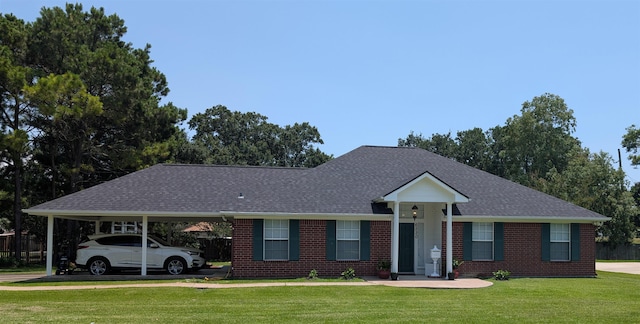 6220 32nd St, Groves, TX 77619 - ranch-style home featuring a front yard, a carport, brick siding, and a shingled roof