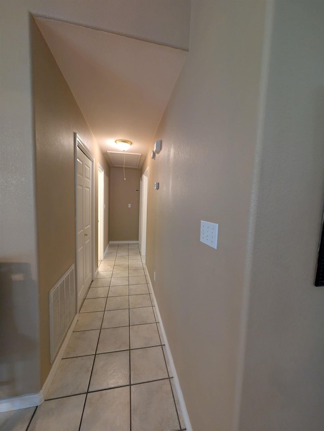6220 32nd St, Groves, TX 77619 - corridor featuring attic access and light tile patterned floors