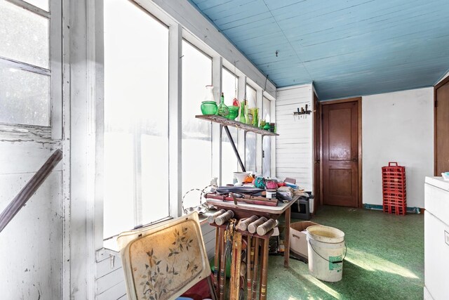 miscellaneous room featuring wooden walls