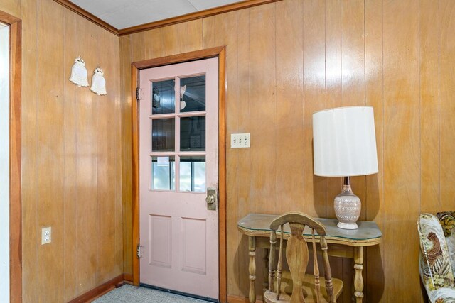 entryway with wood walls