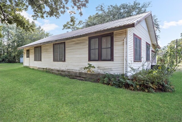 view of property exterior featuring a lawn