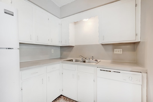 kitchen with white cabinets, a textured ceiling, white appliances, and sink