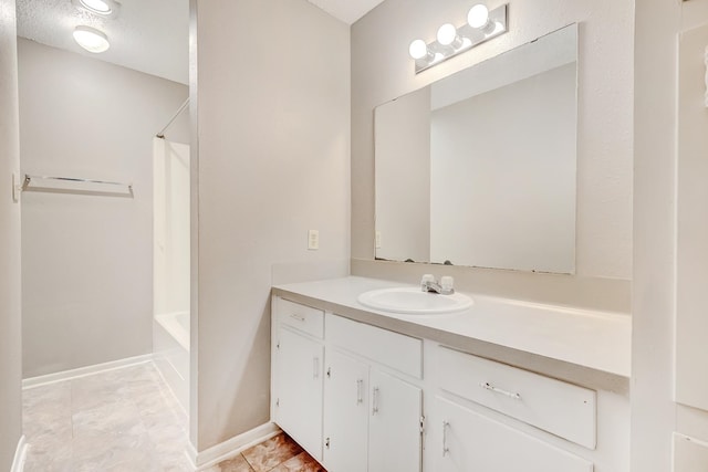 bathroom with tile patterned flooring, a textured ceiling, vanity, and shower / bathtub combination