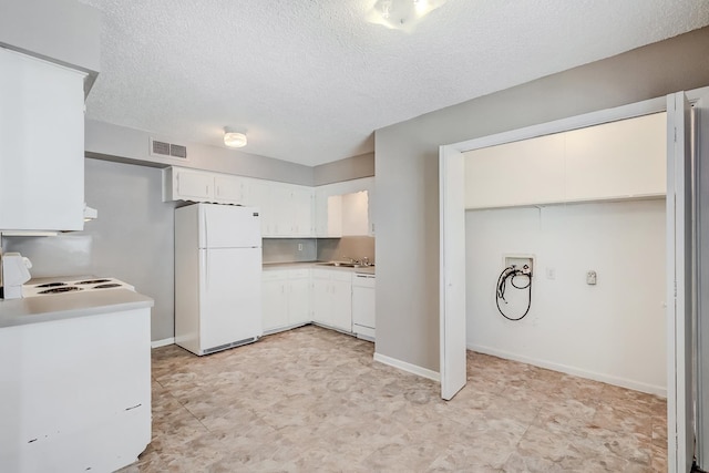 kitchen with white cabinets, sink, white appliances, and a textured ceiling