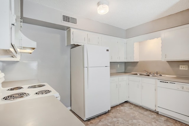 kitchen with white cabinets, white appliances, sink, and a textured ceiling