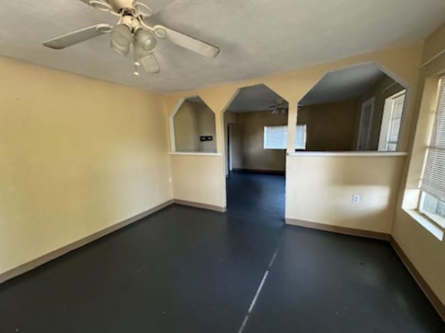 301 W Lavielle, Kirbyville, TX 75956 - empty room featuring a ceiling fan and baseboards