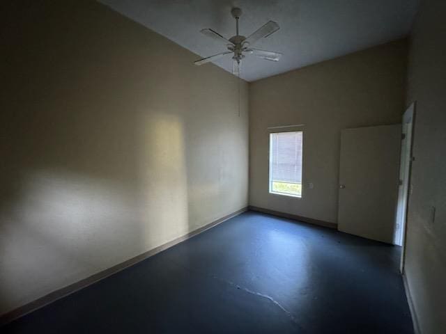 301 W Lavielle, Kirbyville, TX 75956 - spare room with baseboards, concrete floors, and ceiling fan