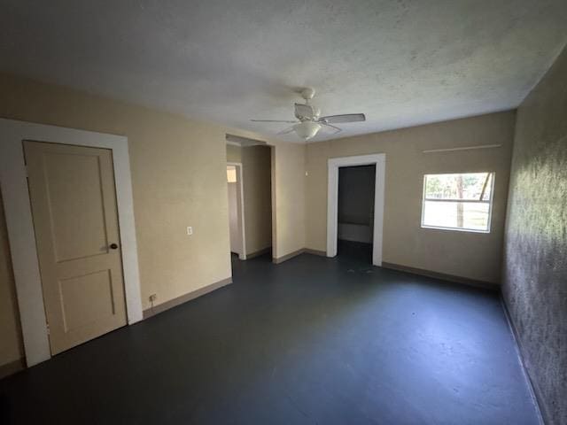 301 W Lavielle, Kirbyville, TX 75956 - spare room featuring concrete floors, a ceiling fan, and baseboards