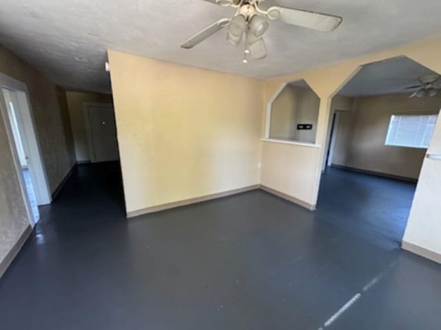 301 W Lavielle, Kirbyville, TX 75956 - empty room with a ceiling fan, baseboards, and concrete floors