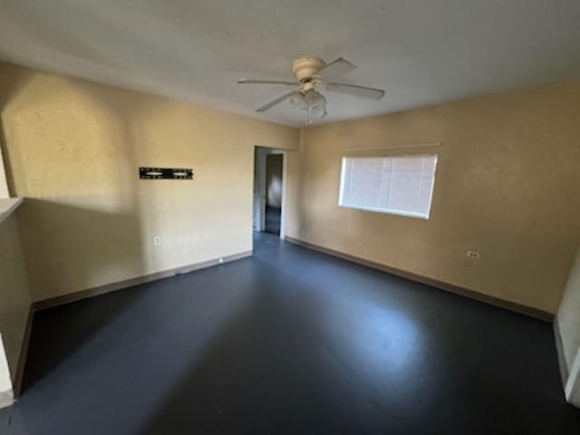 301 W Lavielle, Kirbyville, TX 75956 - unfurnished room featuring a ceiling fan, baseboards, and concrete floors