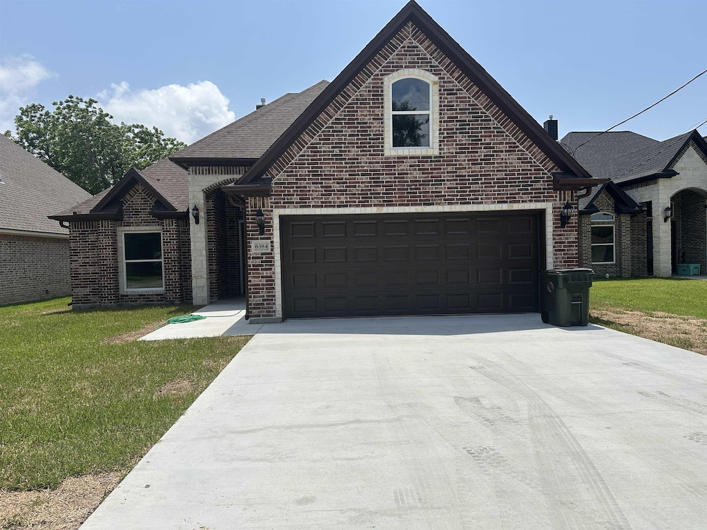 view of front facade with a front yard and a garage