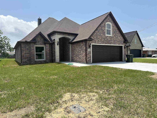 view of front of home with a garage and a front yard