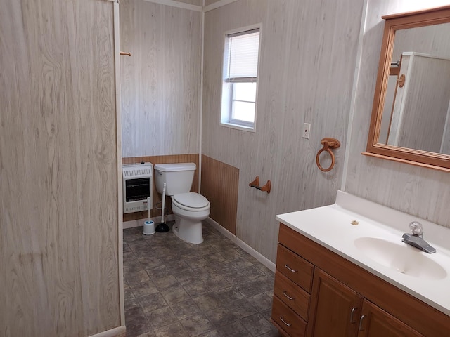 bathroom with vanity, toilet, and heating unit