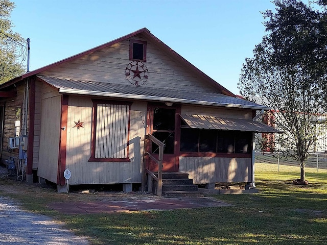 view of front facade with cooling unit and a front yard