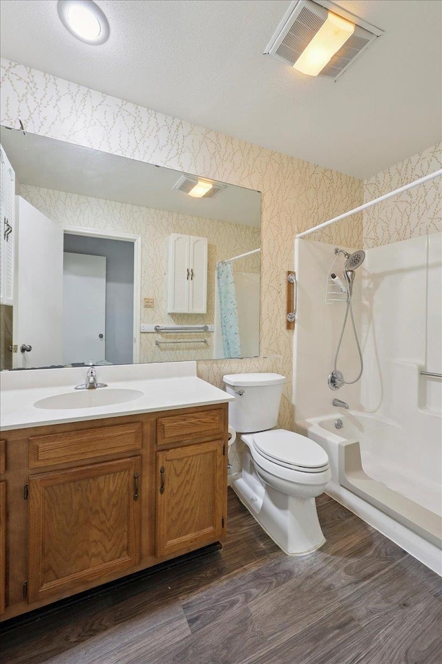 9385 Glen Mdw, Beaumont, TX 77706 - full bath featuring wallpapered walls, wood finished floors, vanity, and shower / bath combination with curtain