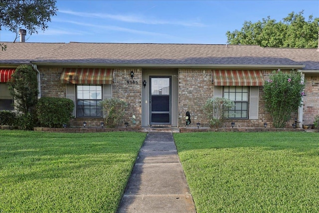 9385 Glen Mdw, Beaumont, TX 77706 - view of front facade featuring a front yard, brick siding, and roof with shingles