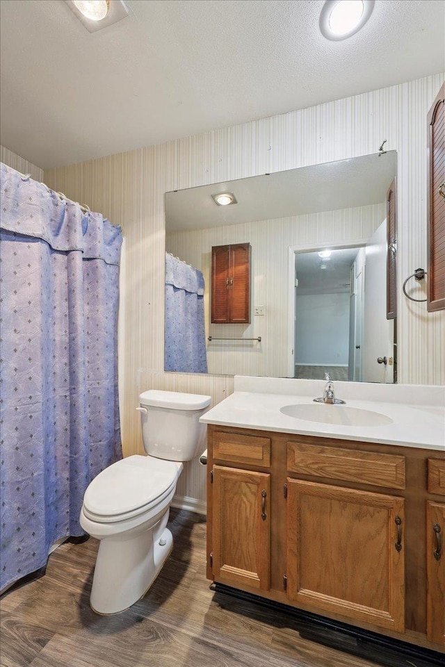 9385 Glen Mdw, Beaumont, TX 77706 - bathroom featuring wallpapered walls, wood finished floors, and vanity