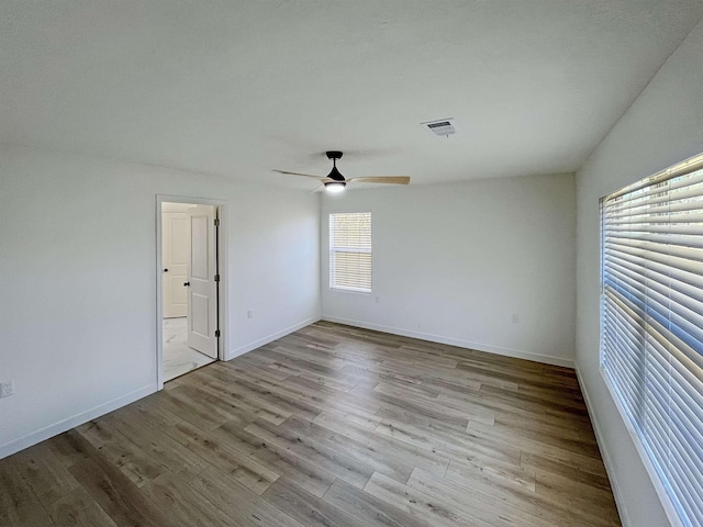 empty room featuring ceiling fan and light hardwood / wood-style floors