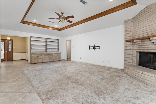 unfurnished living room featuring recessed lighting, a tray ceiling, visible vents, a ceiling fan, and a fireplace