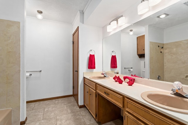 full bath with baseboards, visible vents, a sink, and double vanity