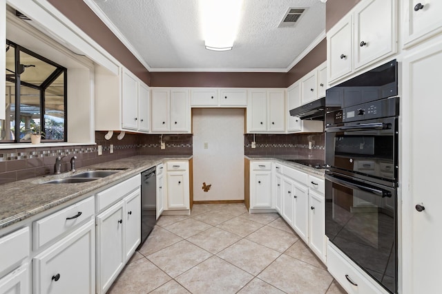 kitchen with a sink, a textured ceiling, black appliances, decorative backsplash, and visible vents