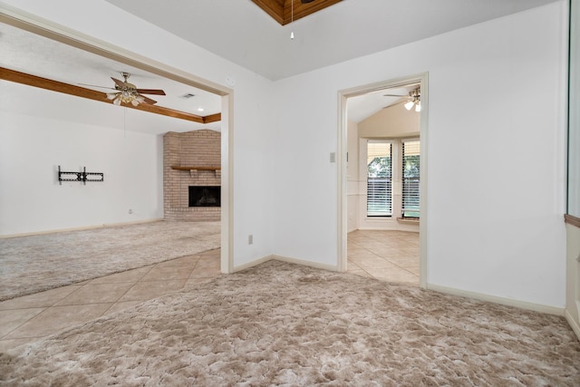 unfurnished living room with baseboards, a ceiling fan, tile patterned flooring, and carpet